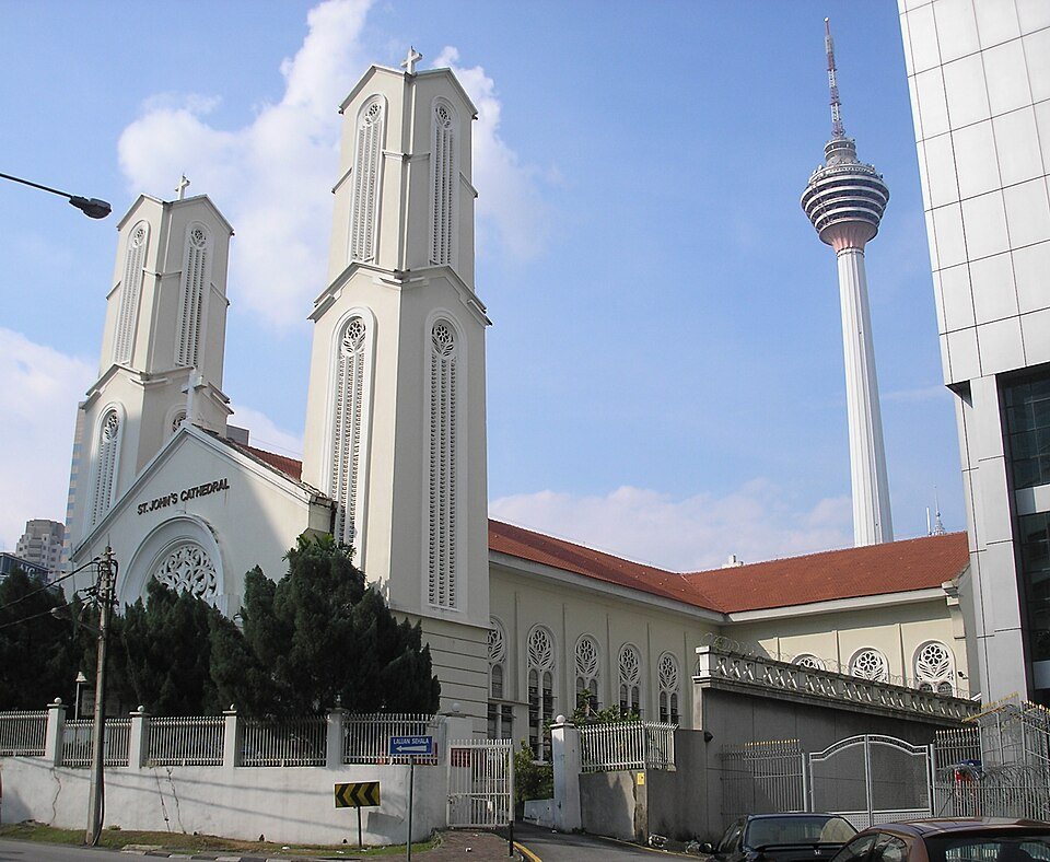 The white twin-spired St John’s Cathedral, with KL Tower behind.
