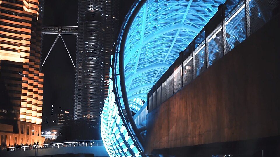 The illuminated steel lattice of Saloma Link at night.